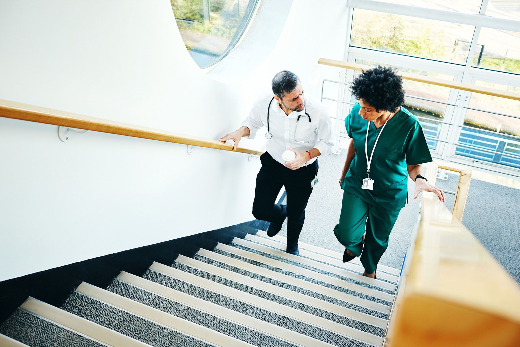 2 health professionals walking up the stairs