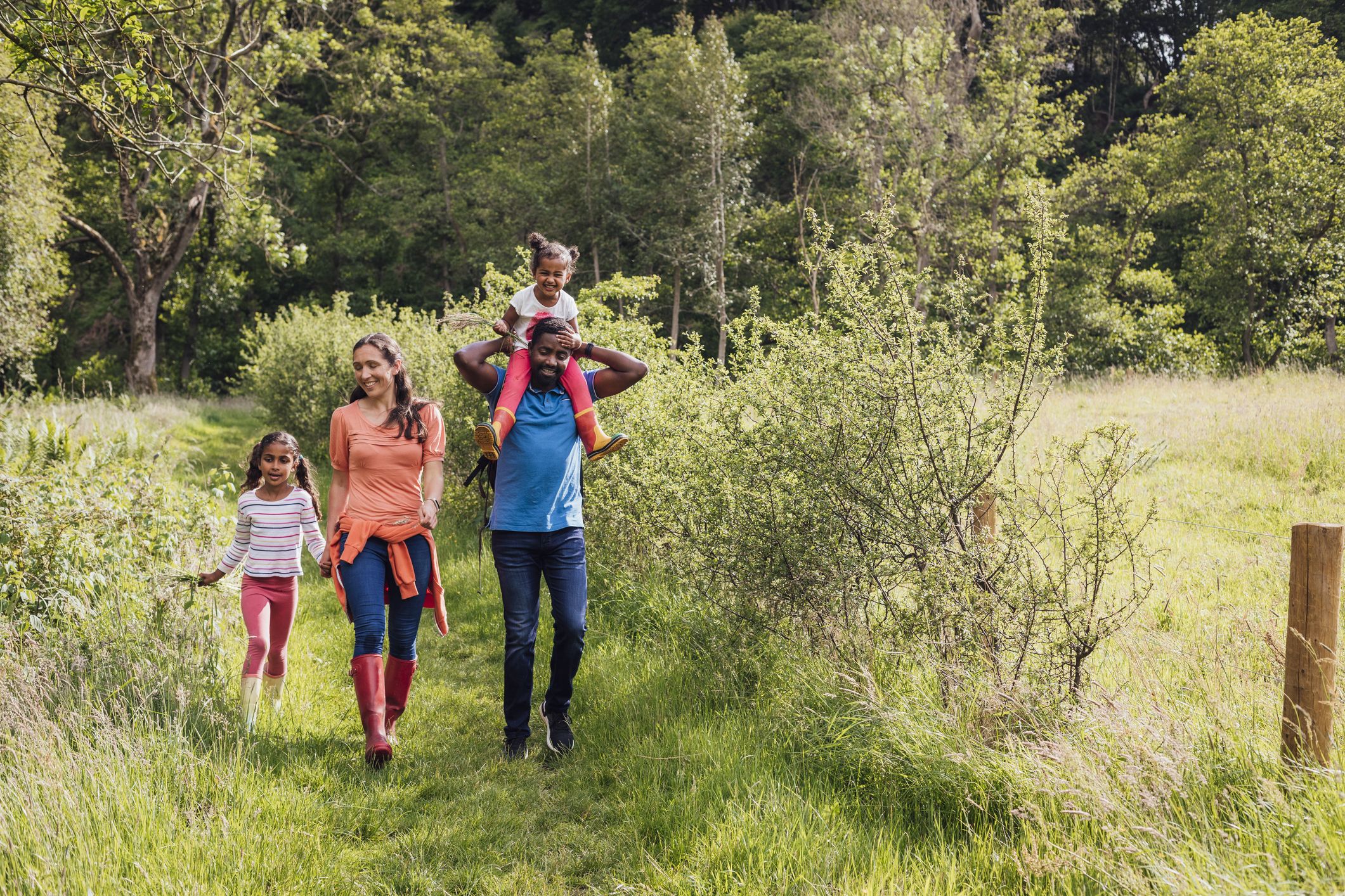 A family on a walk in some woodlands.